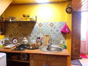 a kitchen with a sink and a counter top at Heart of Old Tbilisi Apartments in Tbilisi City +22 photos