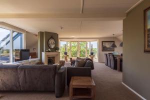 a living room with couches and a fireplace at Appartement Veluwemeer in Biddinghuizen