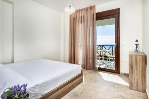 Postel nebo postele na pokoji v ubytování Sunset Villas