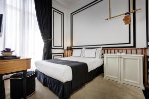 a hotel room with a large bed and a desk at Galata Antique Hotel - Special Category in Istanbul