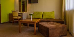 a living room with a couch and a table at Hotel Forum - Free Parking for cars in Sofia