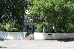 a white wall with stairs in front of a building at Zheleznovodskaya Klinika Sanatorium in Zheleznovodsk