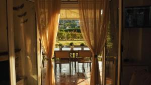 a view of a dining room table through a sliding glass door at Villa Evridiki in Fourka