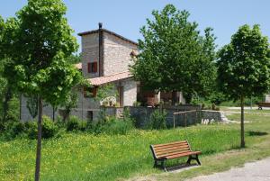 a bench sitting in front of a house at Casale la Torretta in Norcia