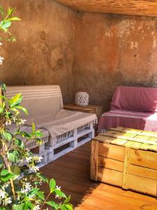 a room with a bed and a couch on a deck at Ca l'Esparrech in Malgrat de Mar