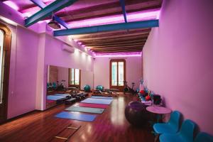 a gym with yoga mats on the floor and purple walls at Ramblas Apartments in Barcelona