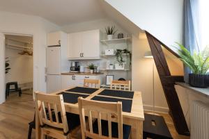 a kitchen and dining room with a table and chairs at Alyhr Apartments in Visby