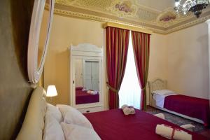 Posteľ alebo postele v izbe v ubytovaní Palazzo degli Affreschi