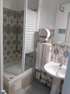 a bathroom with a shower and a sink at Hostal Africa Do Sul in Lisbon
