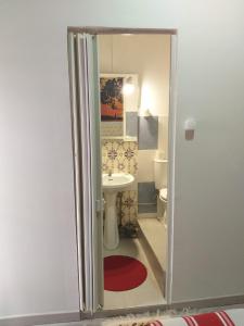 a small bathroom with a sink and a toilet at Hostal Africa Do Sul in Lisbon