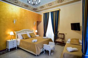 Posteľ alebo postele v izbe v ubytovaní Palazzo degli Affreschi