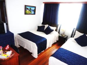 Postel nebo postele na pokoji v ubytování Hotel Casa Sarita