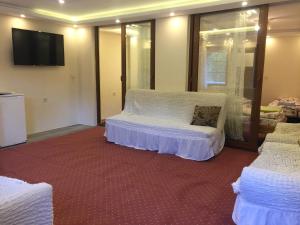 a bedroom with two beds and a flat screen tv at Çam Otel in Uzungöl
