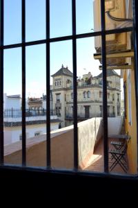 a view of a building from a window at Ático Feria in Seville