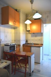 a kitchen with wooden cabinets and a table and a tableablish at Ático Feria in Seville