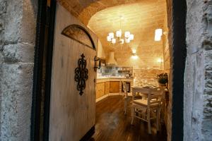 a kitchen and dining room with a table and chairs at L' alcova di Federico in Trani