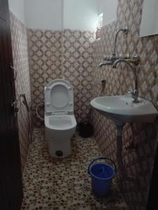 a bathroom with a toilet and a sink at kayastha restaurant & lodge in Bandīpur