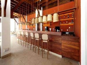 a bar with a row of chairs in a kitchen at African Princess Beach Hotel in Serekunda