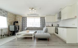 a living room with a couch and a table at Prie Lukos ezero in Trakai
