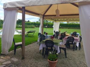 a group of tables and chairs under a tent at Motel Cosmera in Savigliano