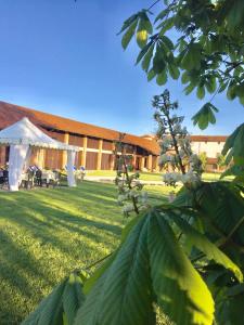 a building with a gazebo and a tent in a yard at Motel Cosmera in Savigliano