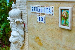 a building with a clock on the side of it at La Casa Primorsko in Primorsko