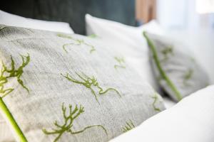 a pillow with plants on it sitting on a bed at Brauerei Zwönitz in Zwönitz