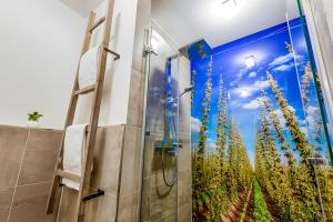 a bathroom with a shower with a mural of a field at Brauerei Zwönitz in Zwönitz