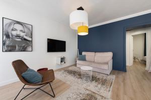 a living room with a couch and a chair at Nouveau F2 calme cœur de ville 1min de la plage in Saint-Raphaël