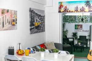 a dining room with a white table and chairs at Live Lisboa Hostel in Lisbon