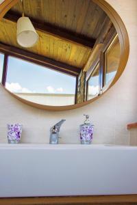 a bathroom with a sink and a mirror at Agripodere Il Falco in Pontremoli