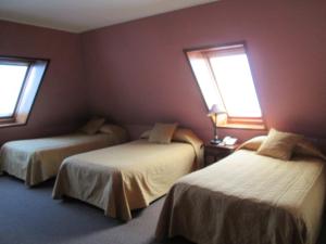 Postel nebo postele na pokoji v ubytování Hotel Apart Colón