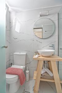 a bathroom with a sink and a toilet at Central Suites Mykonos in Mýkonos City