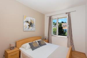 a bedroom with a bed and a window at Hvar Harbor Luxury in Hvar