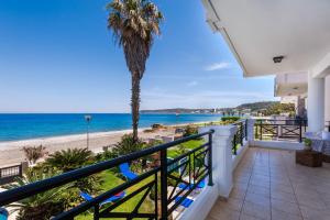 a balcony with a view of the beach and ocean at SeaRene Deluxe Seafront Maisonette in Ixia