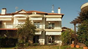 a large white building with a roof at Villa Evridiki in Fourka