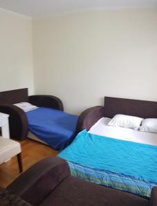 a room with two beds and a couch at Relax in Budva