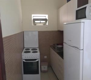 a small kitchen with a stove and a refrigerator at Relax in Budva