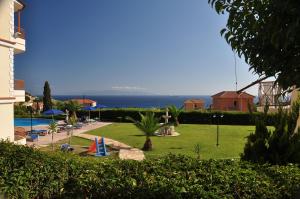 a resort with a swimming pool and the ocean in the background at Marina-Anna Studios in Trapezaki