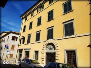 a large yellow building with a clock on it at Colle dei lauri in Loreto