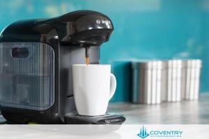 a coffee maker is making a cup of coffee at 2 Bedroom Apartment, NEC, HS2, BHX, JLR - Devereux House, Hosted By Coventry Accommodation in Coleshill