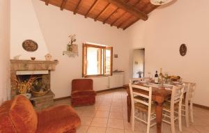 a living room with a table and a fireplace at Borgo degli Orti in Montaione