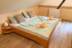 Una cama con toallas y sombreros encima. en Guesthouse Draga, en Begunje na Gorenjskem