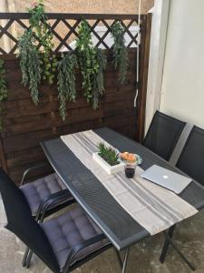 einen Tisch mit Stühlen und einen Laptop auf einer Terrasse in der Unterkunft Apartment Milin in Olib