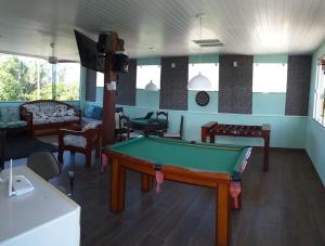 a living room with a pool table in it at Airport Pousada in Cabo Frio