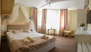 a bedroom with a bed with two pillows on it at Golden House in Varna City
