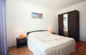 a bedroom with a large bed and a mirror at Holiday home Elis in Fažana