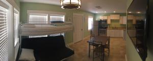 a small room with a bunk bed and a kitchen at The Catalina in Panama City Beach