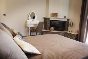 a bedroom with a bed with a fireplace and a television at Tenuta Serena Apartments in Molfetta
