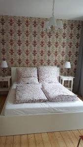 a bedroom with a white bed with two night stands at Ferienhaus BARFLY in Traben-Trarbach